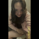 Emi twerks over a public toilet, then sits and rubs herself while staring into the camera as she shits into the bowl. Vertical format video. Over 9 minutes.